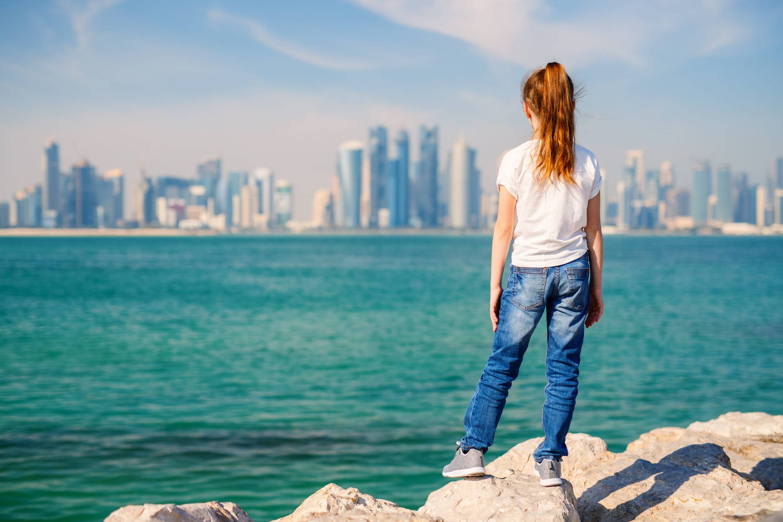 A Young Tourist Viewing The Doha Skyline