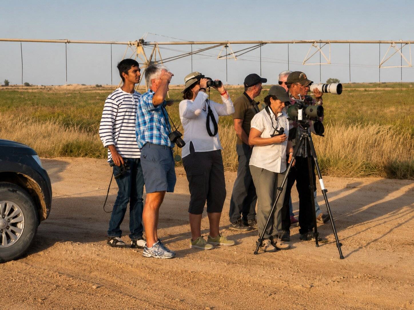 People Taking Turns Birdwatching In Qatar
