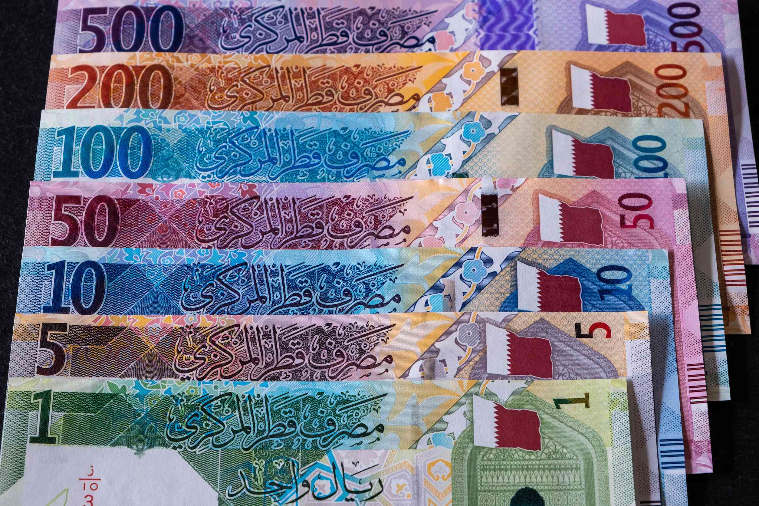 Qatari Riyal Banknotes On A Black Background