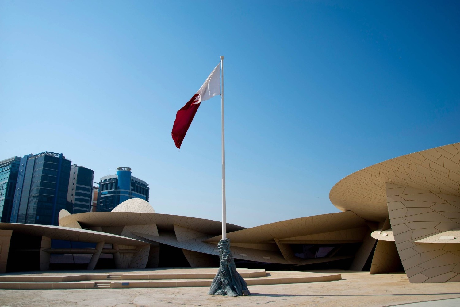 The Flag Of Qatar In Front Of The National Museum Of Qatar