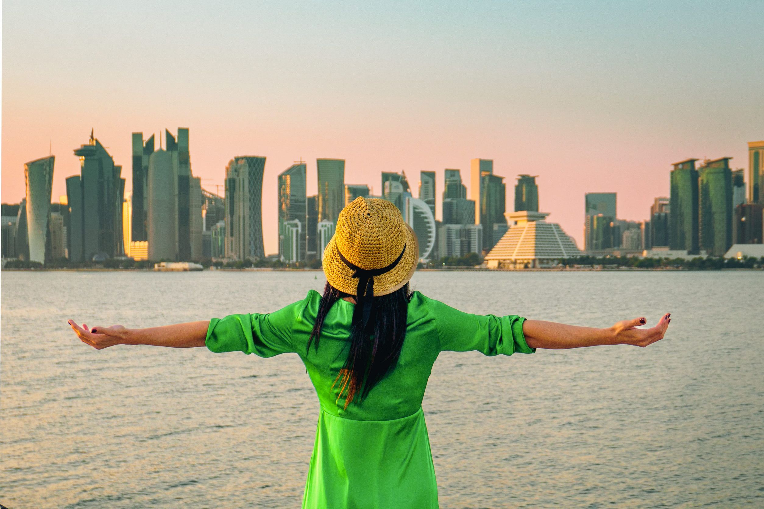 Woman overlooking the Doha skyline waterfront